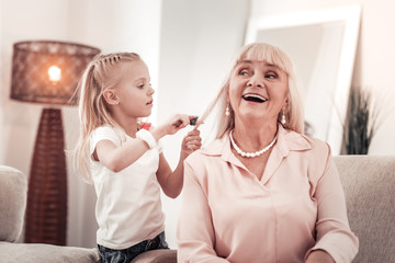 Blond long-haired elderly smiling woman feeling contented