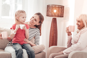 Beautiful long-haired mother feeling gorgeous with her daughter
