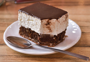 bitten cake on a plate with a spoon, cake Volga