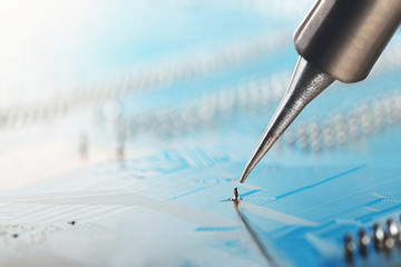 Soldering of electronic circuit board with electronic components. Soldering station. Engineers...