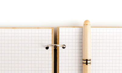 Open notebook with wooden cover and checkered pages with a pen in a wooden case on top. Back to...