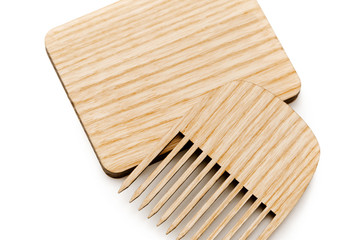 Compact hair comb with a cover of recyclable material. The concept of eco-friendly use of household items. Isolated on white background.