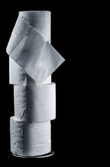 Pyramid of white two-layer toilet paper on a black background, isolate