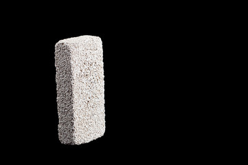 pumice stone for washing heels on a black background isolate