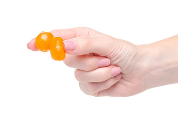 Candied dried kumquat in hand on white background isoltion