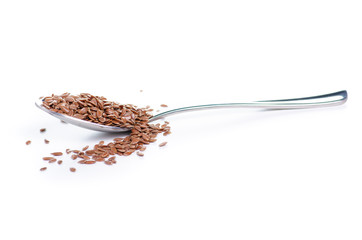 flax seeds in spoon on white background isolation
