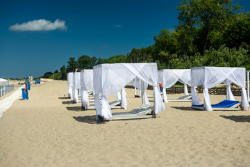 wooden sunshades on the beach comfortable loungers