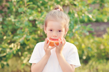 girl in nature with grapefruit, orange fruit