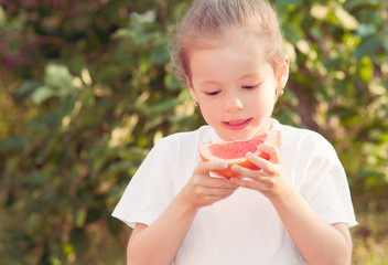 girl in nature with grapefruit