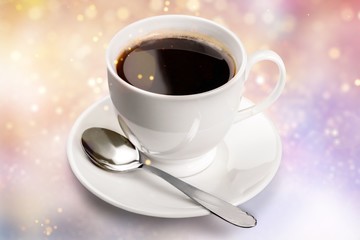 Coffee cup and spoon on wooden background