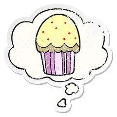 cartoon cupcake and thought bubble as a distressed worn sticker
