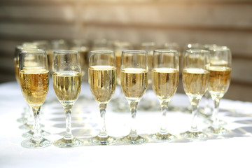 transparent champagne glasses on a white table