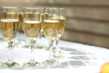transparent champagne glasses on a white table