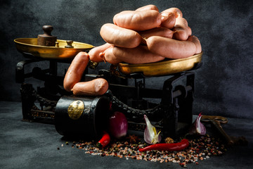 big heap of short thick wieners in spiral with onion and chili