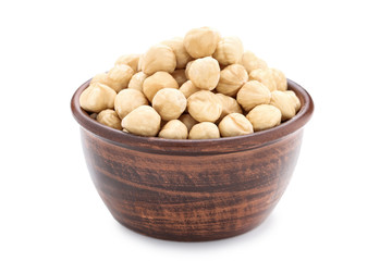 Peeled hazelnuts in bowl on isolated white background