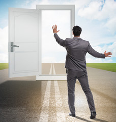 Businessman in front of door in business opportunities concept