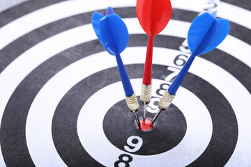 Dartboard with red and blue darts