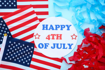 Fototapeta premium Text Happy 4th of July with american flags on blue background