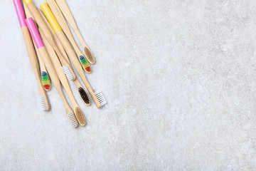 Bamboo toothbrushes on grey background