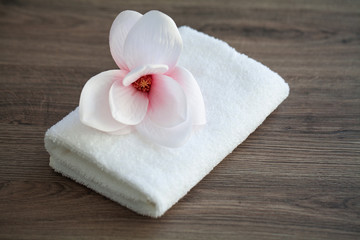 Spa orchid with soft towels on wooden table