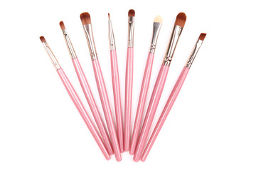 Pink makeup brushes isolated on white background