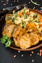 Fried chicken fillet with vegetables.