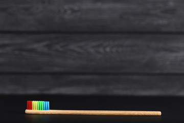 Bamboo toothbrush on black wooden table