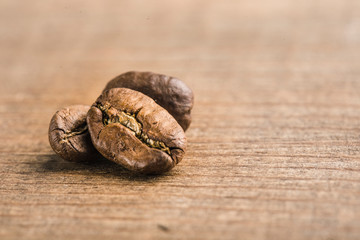Coffee beans closeup on wooden background with copyspace