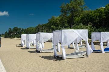 wooden sunshades on the beach comfortable loungers