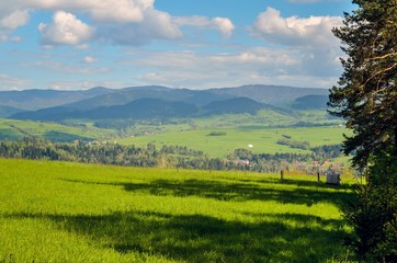 Beautiful rural mountain landscape. Charming villages in the valleys between the green hills.