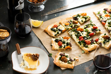 Phyllo Pastry Pizza on Brown Parchment Paper with Wine and Cheese
