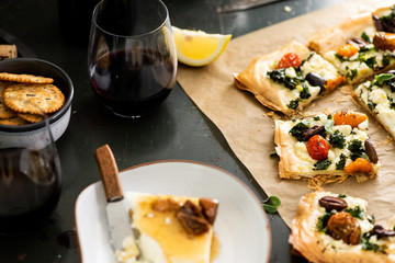 Phyllo Pastry Pizza on Brown Parchment Paper with Wine and Cheese