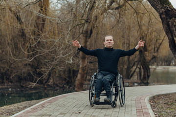 Portrait of a happy man on a wheelchair in a park