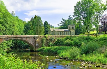 Fototapeta premium Askham Bridge and St Peter's Church, Askham, Cumbria, England