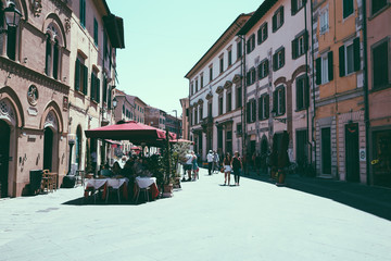 Walking on Borgo Stretto street in Pisa city with historic buildings - Powered by Adobe