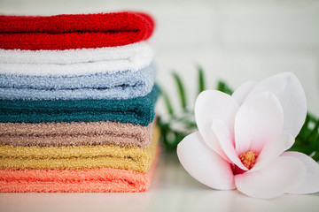 Towels and a branch of an orchid on a white background. Aromatherapy. Spa and Hygiene