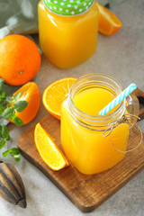 Refreshing juice made of orange, cold drink on a stone or slate background. Concept fresh vitamins. Rustic style.