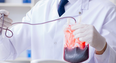 Doctor working with blood samples in hospital clinic lab