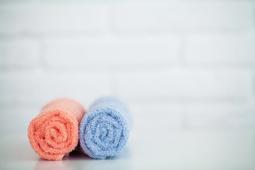 Obraz na płótnie Canvas Colorful cotton towels in bathroom on white wooden table