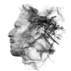 Double exposure portrait of a sexy statuesque man with dark features blending into a curtain of smoke