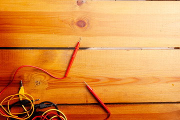 An assortment of cables are laying on a wooden surface