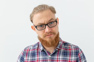 Emotions and people concept - Portrait of serious man with red beard on white background