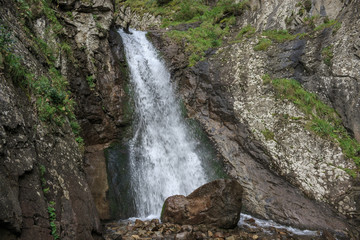 Fototapeta na wymiar Closeup view of waterfall scenes in mountains, national park Dombay, Caucasus