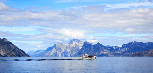 Fishing boat with landscape Greenland, beautiful panorama Nuuk fjord, ocean with mountain background