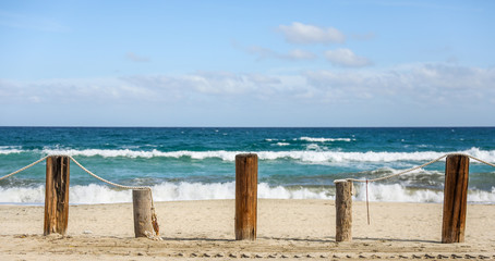 posts along the beach connected by rope