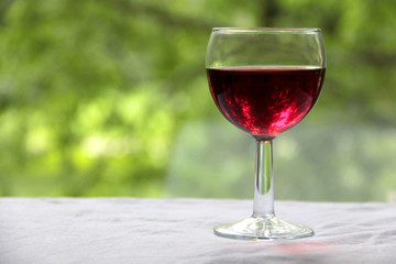 Vintage glass goblet on green background