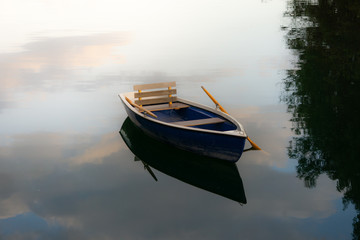 Image of wooden rowing boat on lake