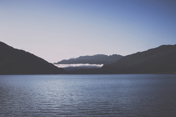 Panorama of Thun lake and away mountains in city Spiez, Switzerland