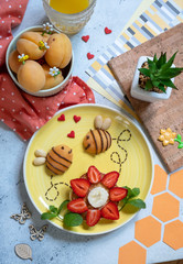Pancake with fruits look like a flower and bees for kids breakfast