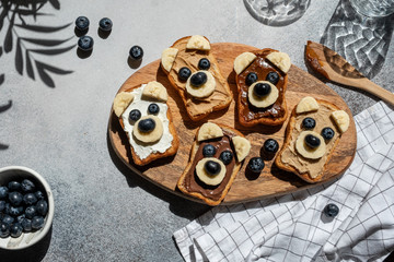 Funny children bear toasts with nuts butters